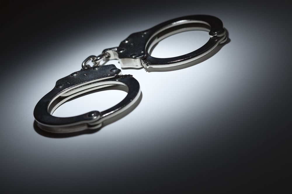 Abstract Pair of Handcuffs Under Spot Light - Text Room