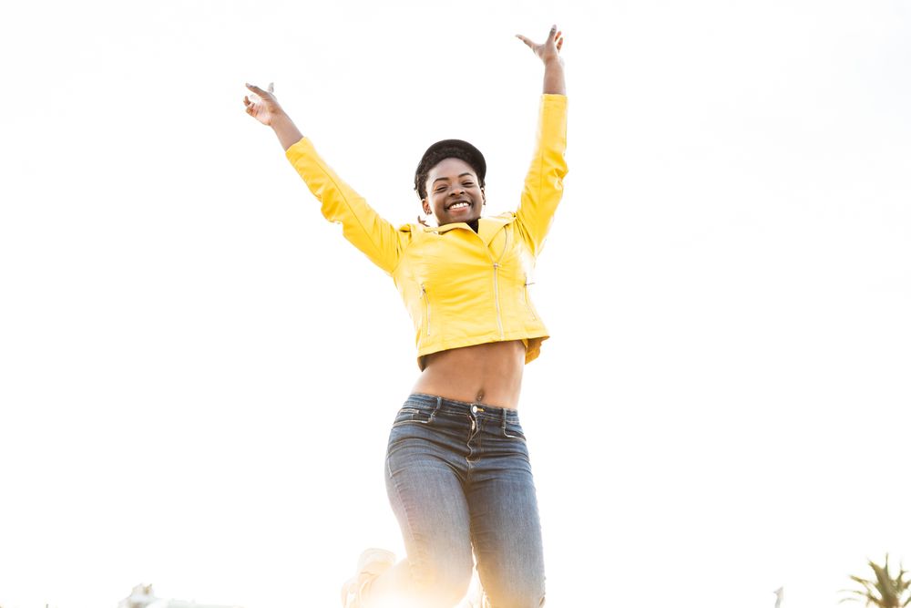 Joyful female smiling and jumping