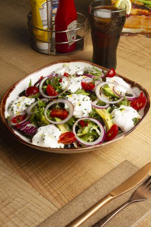 Vegetables salad with onion greens and cream sauce