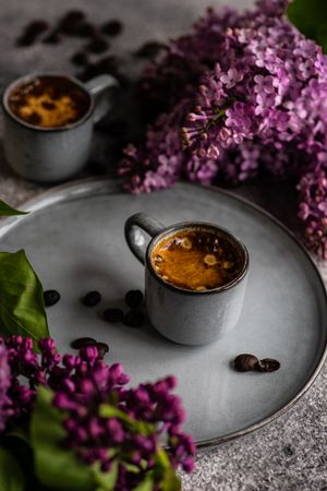 Cup of coffee and lilac flowers