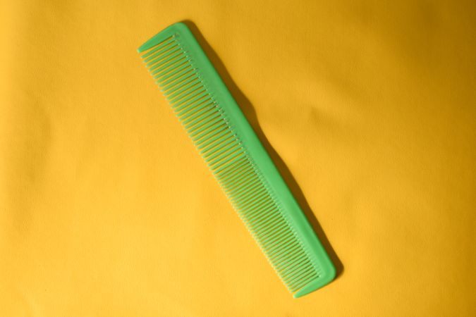 Green comb in yellow studio shoot