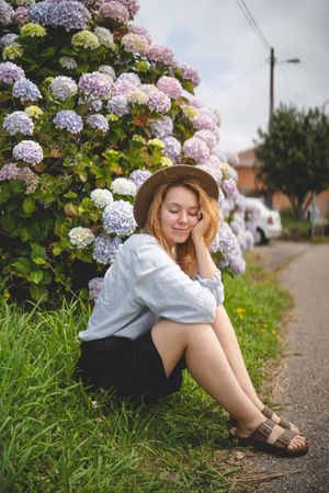 Woman among hydrangeas bushes