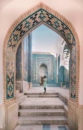 Woman walking in old archway