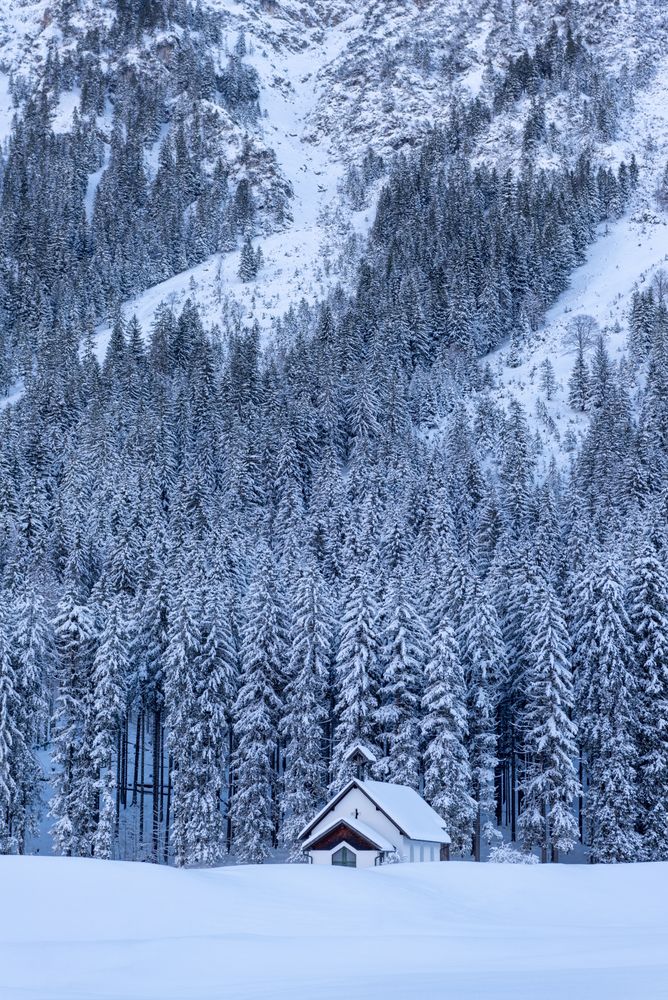 Mountain church in a deep snow nature, winter scenery in the Bavarian Alps, Germany