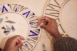 Female designer assembling colorful panels on a wooden frame