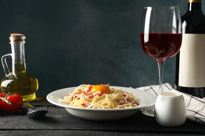 Composition with plate of tasty pasta on wooden background. Cooking pasta