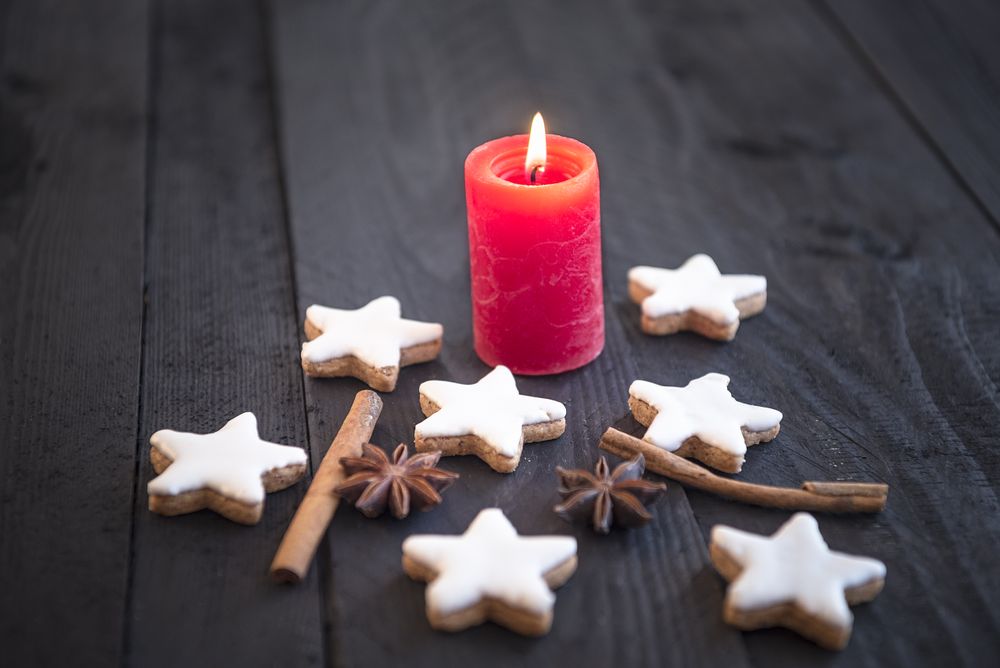 Lit candle and cinnamon cookies