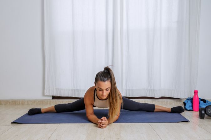 Young woman exercising for middle spilt stretch