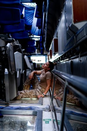 Military woman looking up inside vehicle