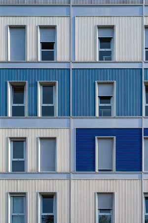 Facade of modern multicolored building with narrow windows