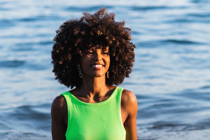 Black woman standing in sea during summer vacation