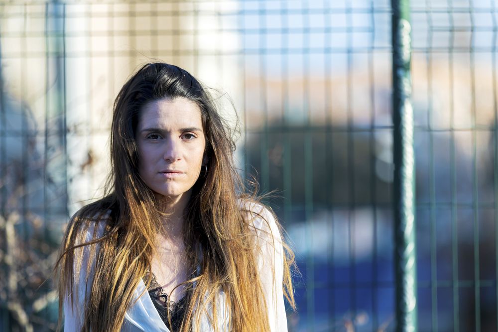 Worried woman sitting outside