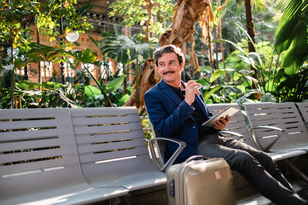 Mature handsome man using digital tablet outdoors