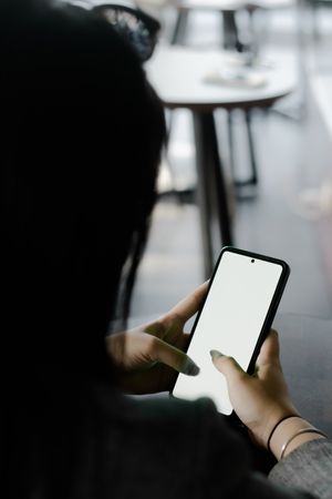 A woman interacts with her smartphone, showcasing modern communication