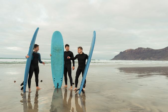 Excited men with surfboards