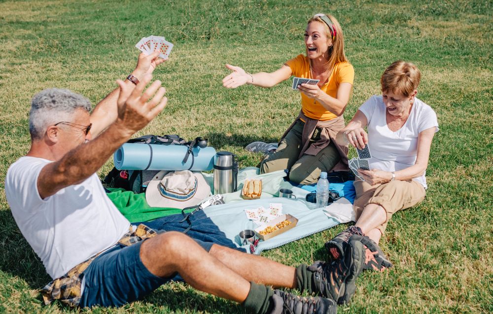 Father winning card game during a picnic