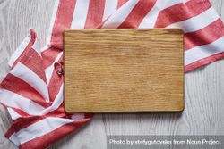 Wooden cutting board on red striped fabric bGzeA4