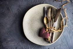 St. Valentine day table setting with felt hearts, string and cutlery, with copy space