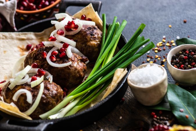 Georgian plate of abkhazura meat cutlets with pomegranate seeds and onions