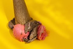 Ice cream cone dropped on yellow background