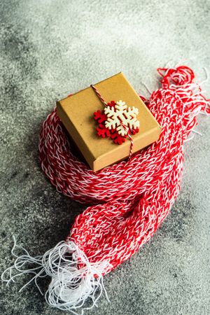 Knitted scarf surrounded Christmas gift