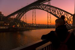 Woman looking at river and city in evening