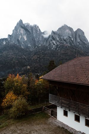 Lonely house in field by mountain