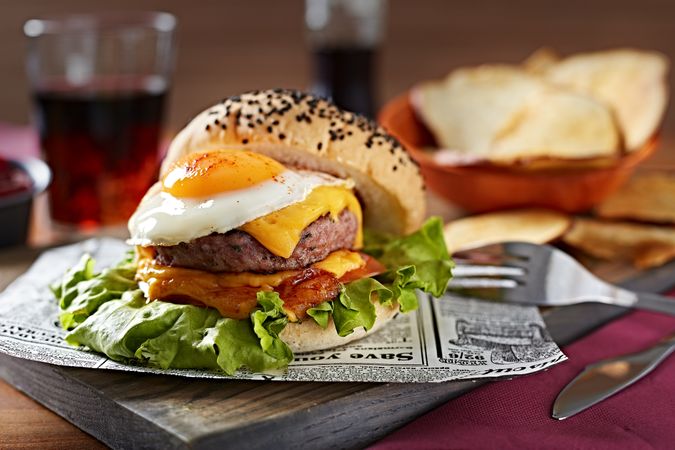Appetizing burger with knife on board