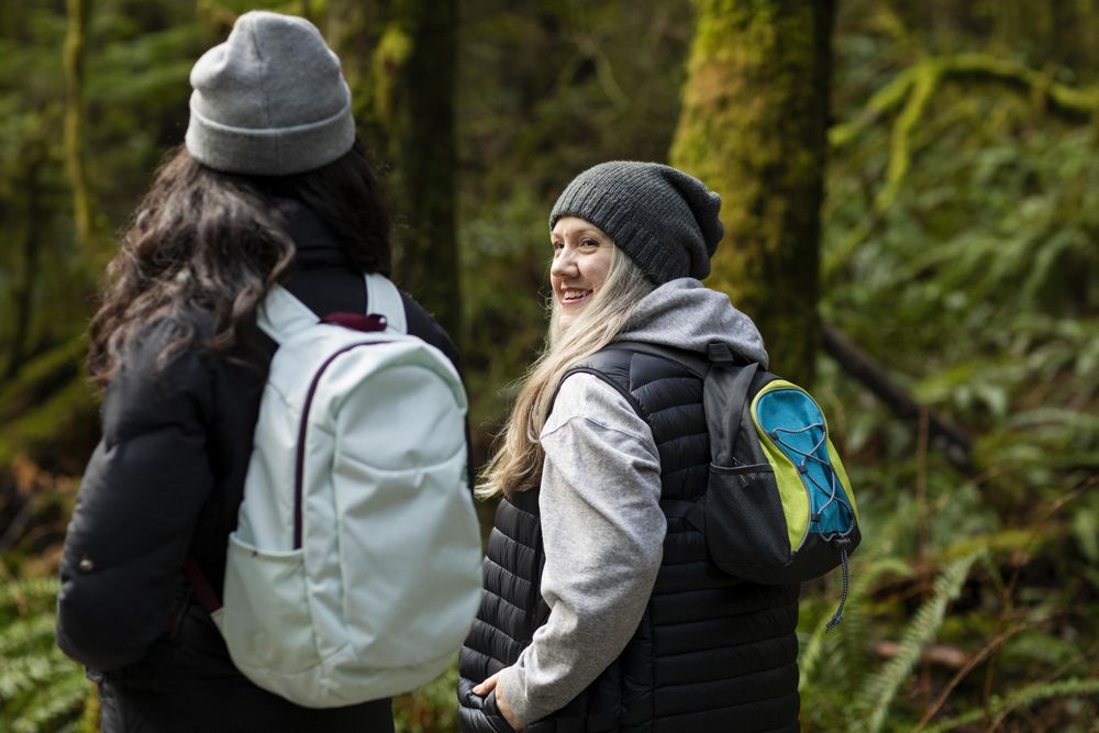 Woman looking at young female during a conversation outdoors