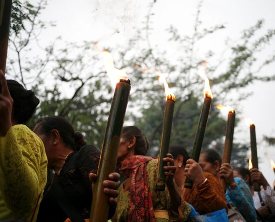 Row of Indonesian women with lit torches