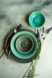 Summer table setting with patterned teal plates lavender flowers