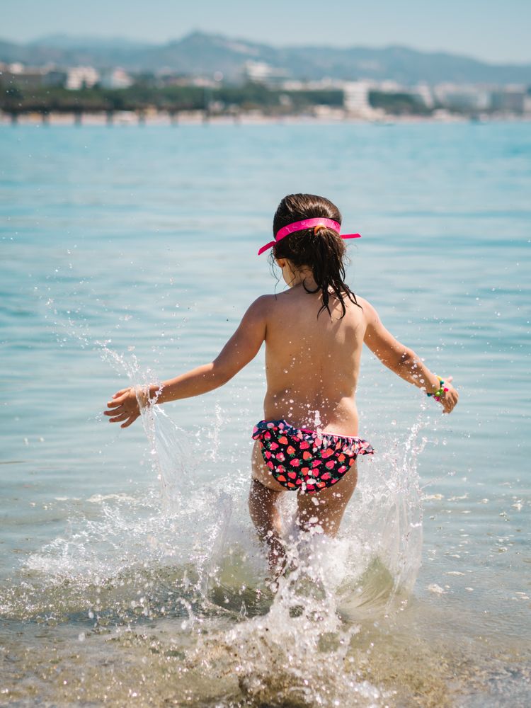 Cheerful girl having fun in warm sea