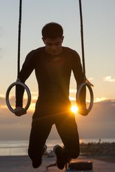 Sportsman training on gymnastic rings