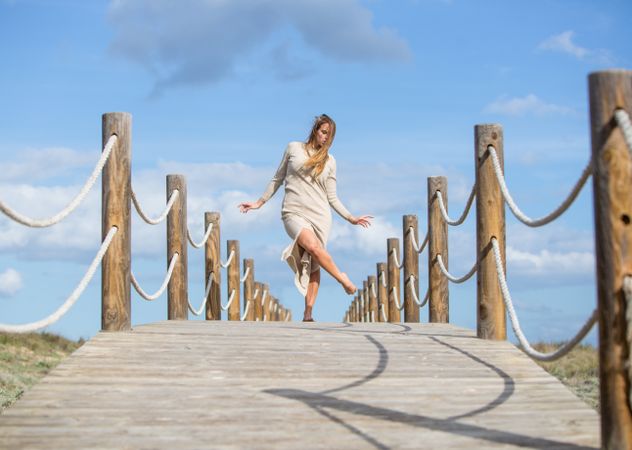 Young woman posing on footbridge