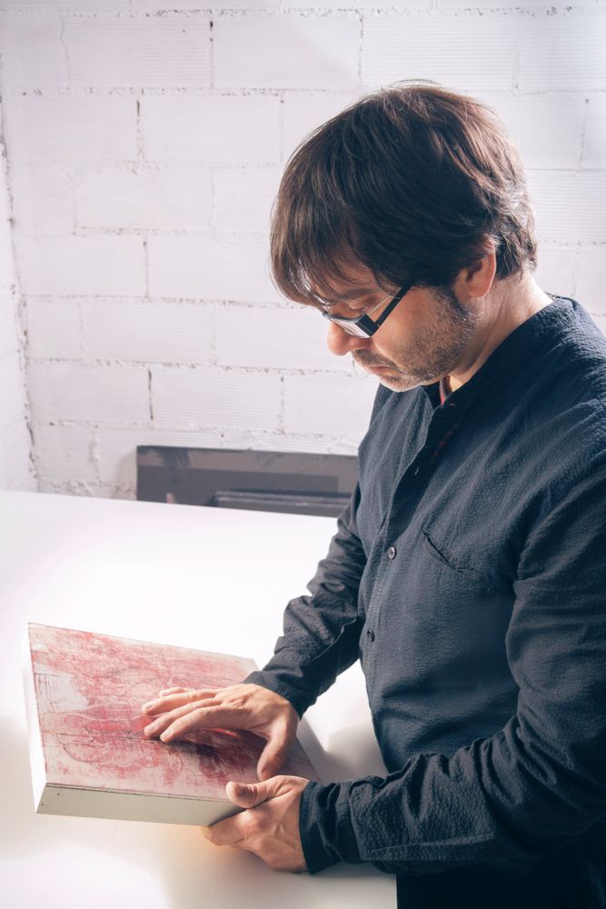 Painter artist reviewing his finished modern artwork