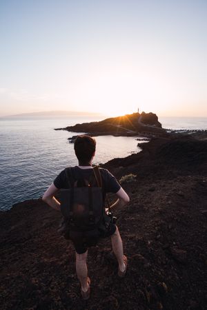 Photographer picturing sunset above remote coast