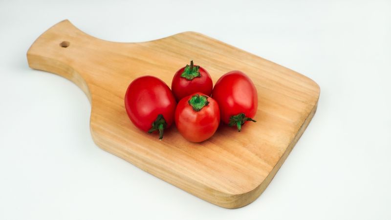 Pile of tomatoes on a wooden board
