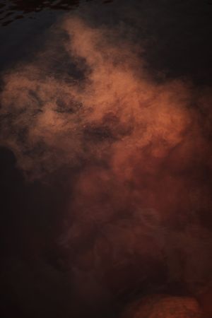 Smoke over water in brown light