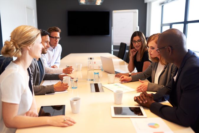 Business associated sitting around table discussing charts and graphs