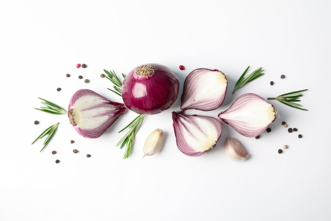 Flat lay composition with red onion and spices on blank background