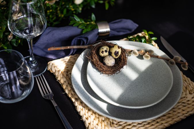 Easter table setting with decorative nest and branch on elegant table