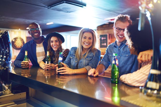 Group of friends sitting at the bar with beer