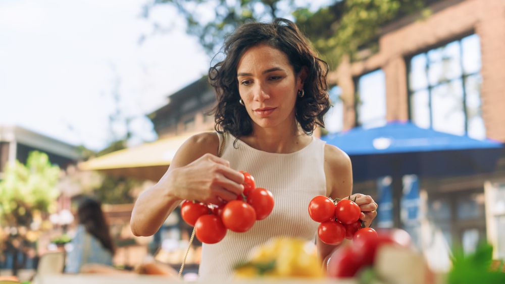 Young Customer Shopping for Fresh Seasonal Fruits and Vegetables for a Mediterranean Dinner.