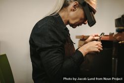 Female jeweler making new product in workshop 56vON5