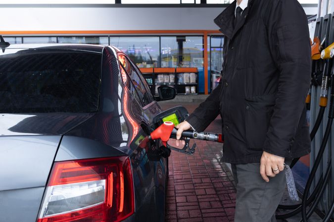 Man Refueling Car – Oil Prices and Green Energy
