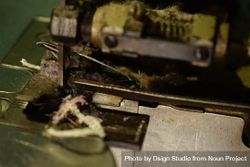 Close up of fabric strip tailor's bronze sewing machine 4BadqB