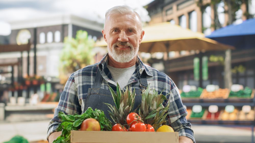 Portrait of a Man Managing a Street Vendor Food Stand with Fresh Natural Agricultural Products.