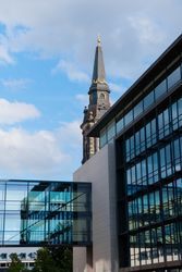 Walkway of corporate building with spire in background