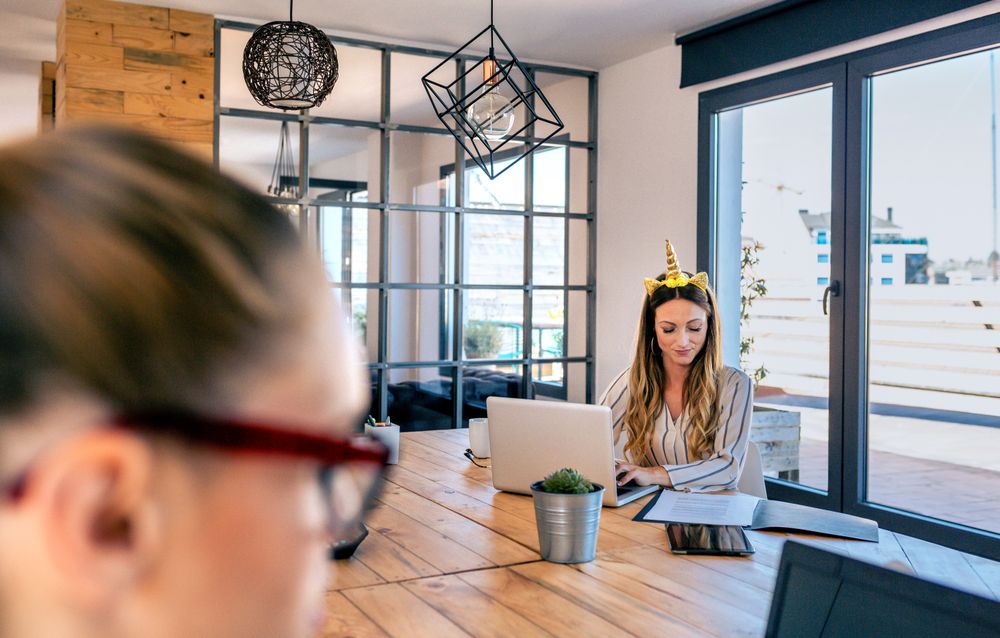 Businesswoman with unicorn headband working