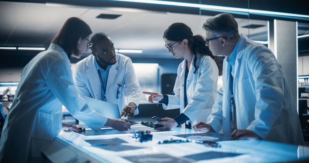 Portrait of a Group of Industrial Robotics Engineers Working on a Humanoid Robot